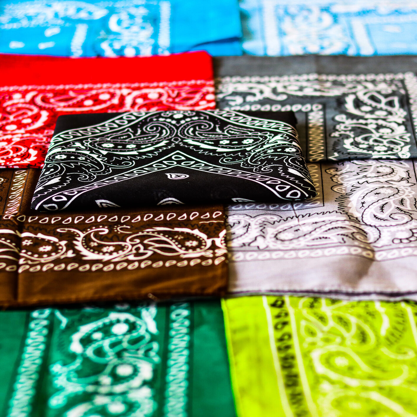 Arrayed coloured handkerchiefs, low angle bright close-up Arrayed coloured handkerchiefs, low angle bright close-up, black, brows, green, blue, yellow, grey
