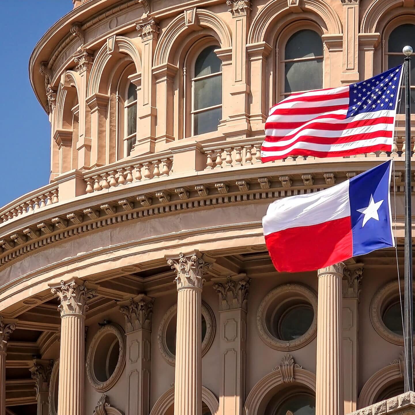 American and Texas Flag Flying, Texas State Capitol in Austin American and Texas state flags flying on the dome of the Texas State Capitol building in Austin